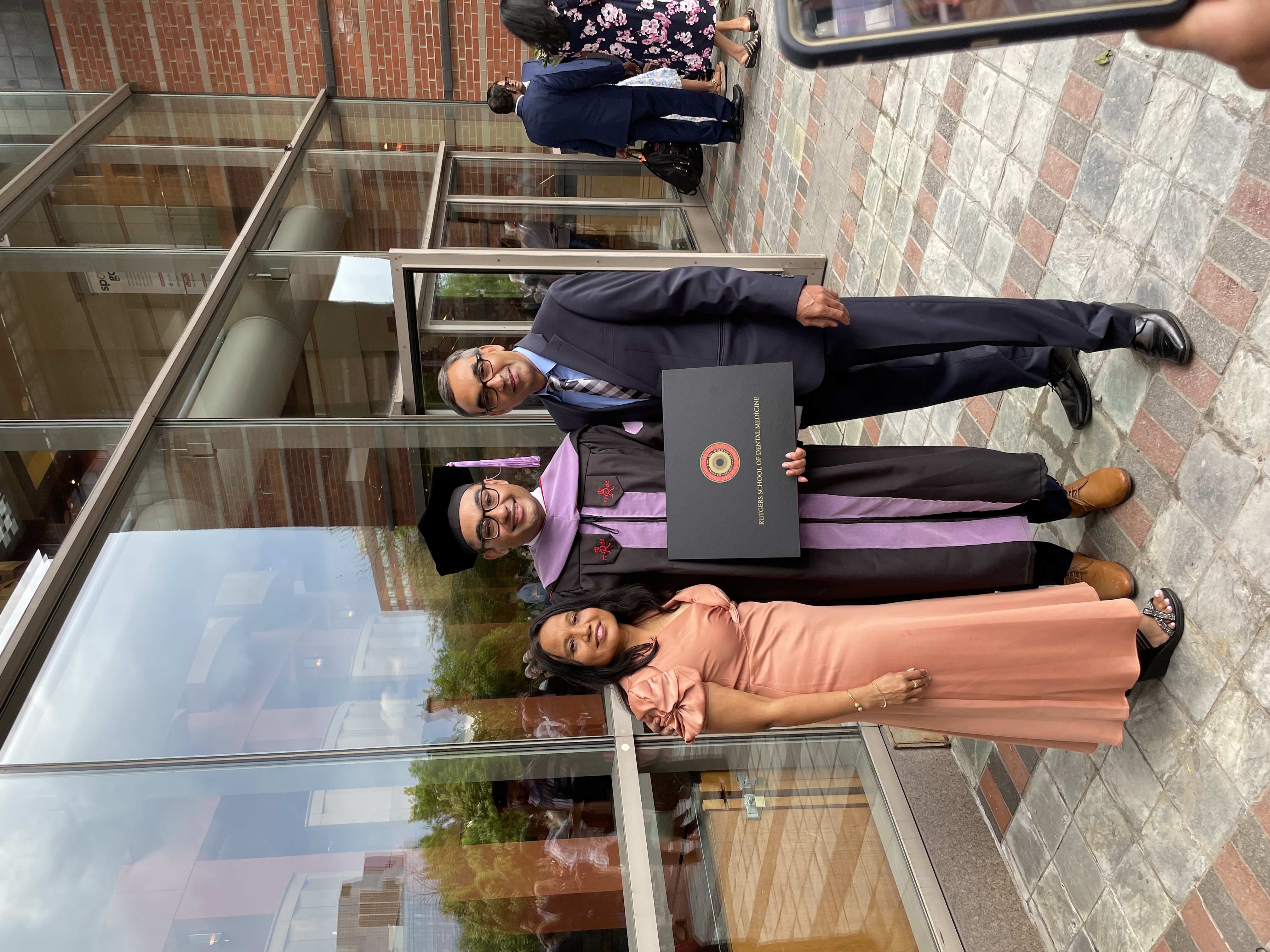 Dr. Jay Patel, DMD at his dental school graduation, with his parents